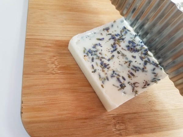 Cutting homemade oatmeal lavender soap with a soap cutter