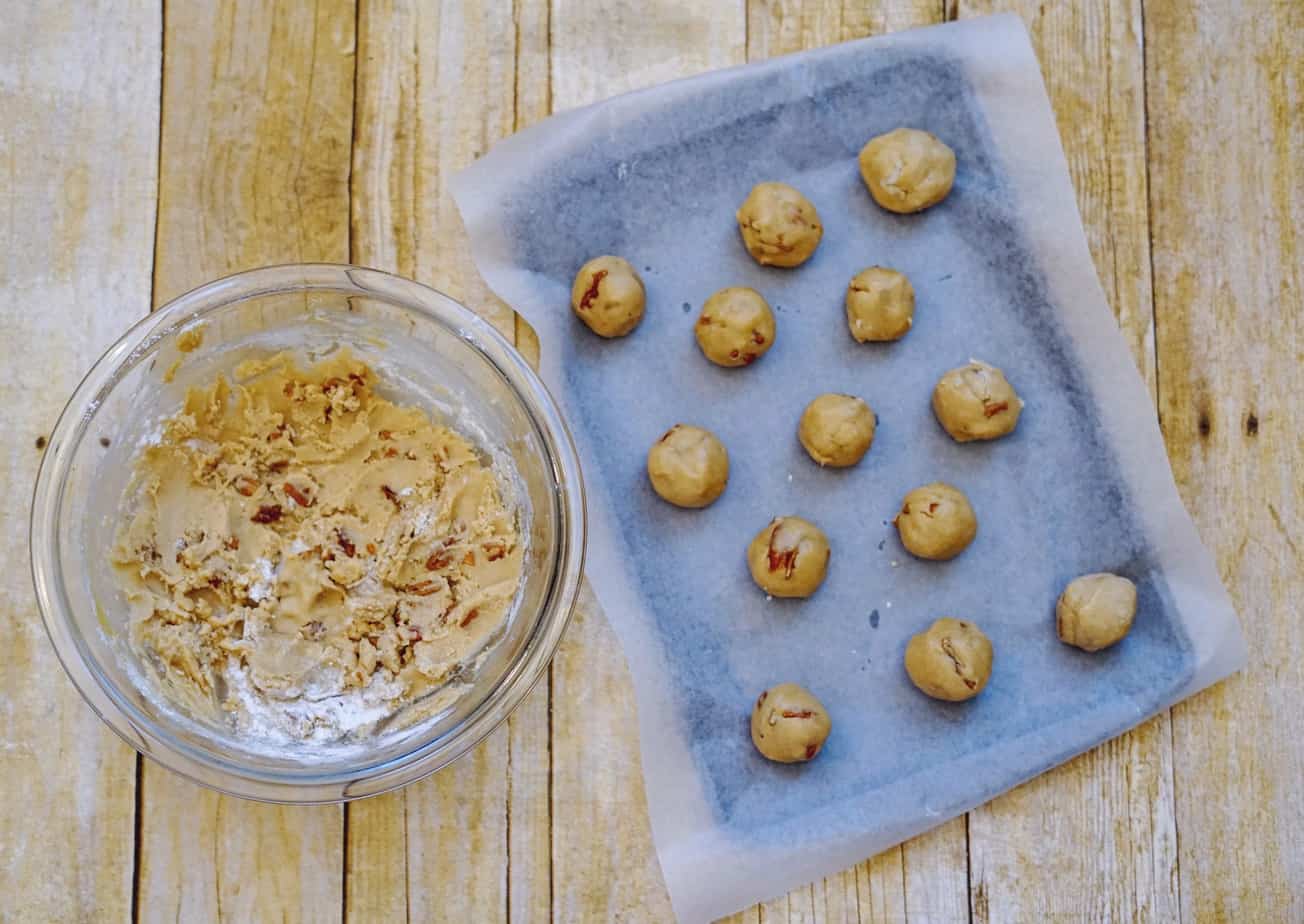 rolling pecan cookie dough into balls 